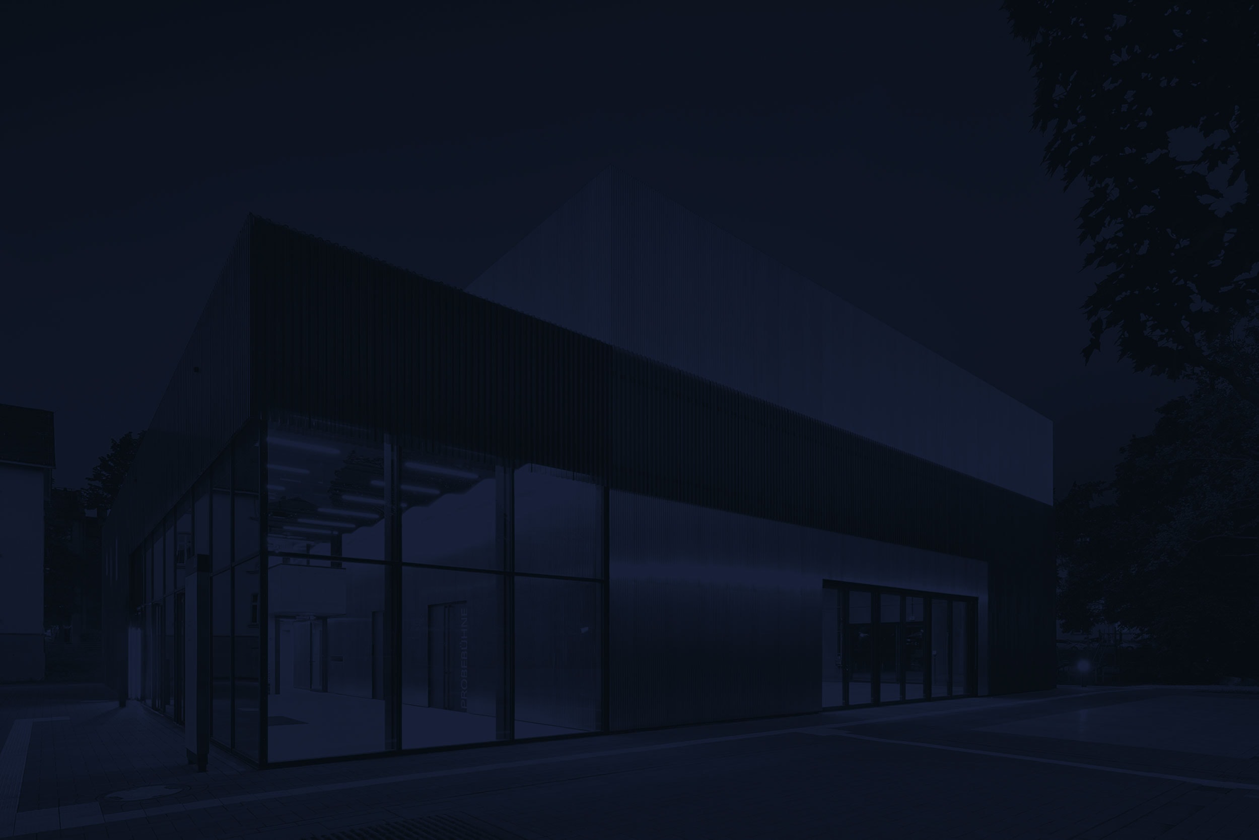 Ein tolles Theater in Gießen mit goldenen Elementen und großen Fensterfronten, der blaue Filter über dem Bild dient dem Design der Website